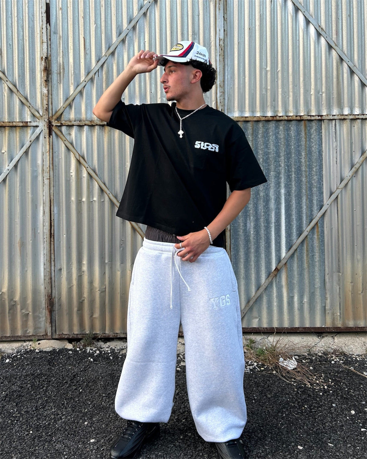 Model wearing the 5Loop Chrome Arms black T-shirt, front view showing the boxy cropped fit