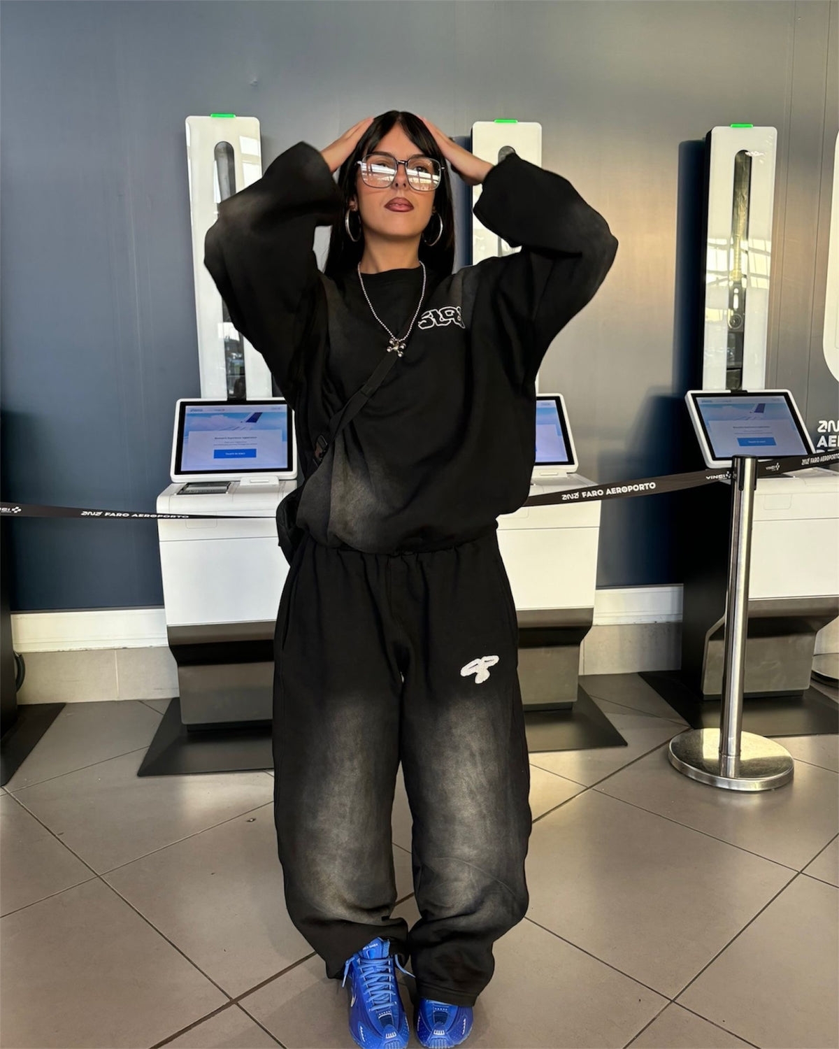 Model wearing the 5Loop 5ivFaded black crewneck sweatshirt and matching sun-faded sweatpants