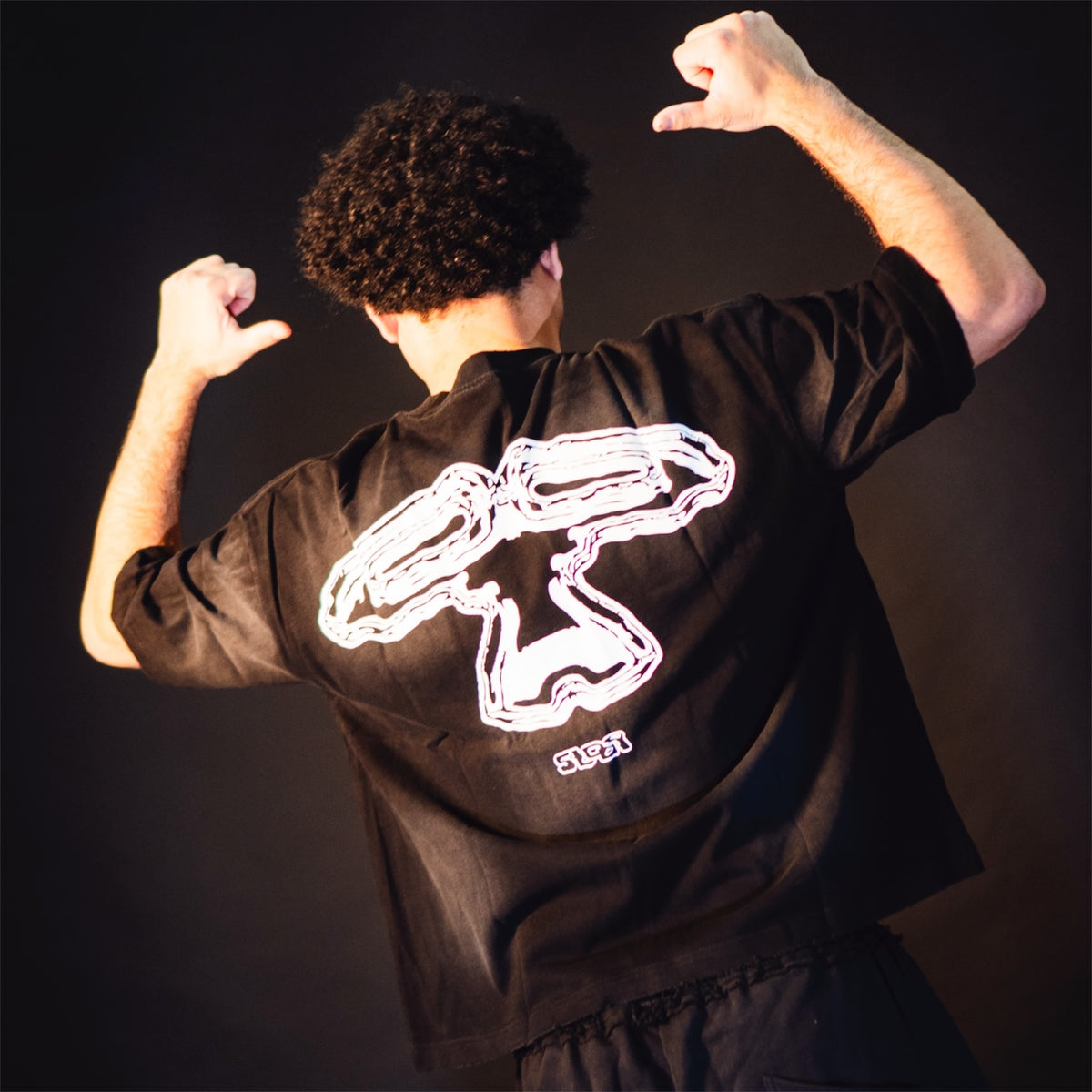 Model wearing the 5Loop 5IVFADED black T-shirt, back view showing the large graphic print